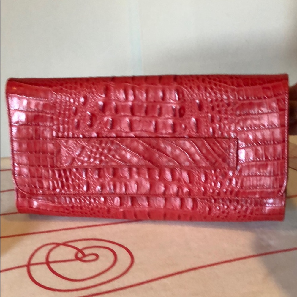 Embossed 💯 leather clutch in ruby red almost new